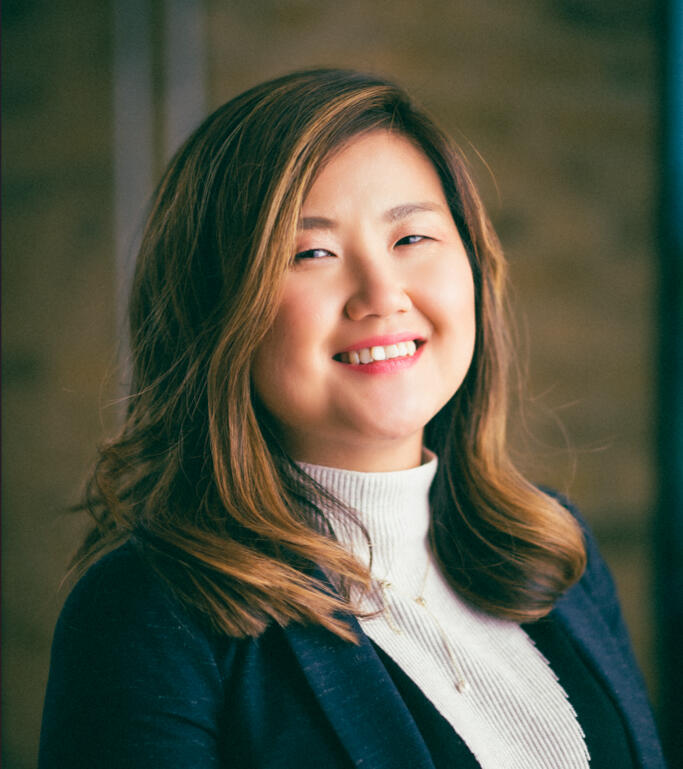 Qin Su - Financial Coach and Author of The Calm Pound Qin Su, author and financial coach, smiling in professional headshot